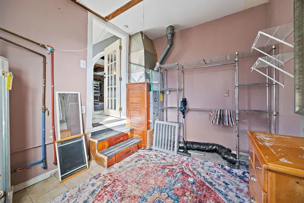 a bedroom with bed and wooden floor