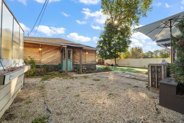 a view of a house with backyard porch and sitting area