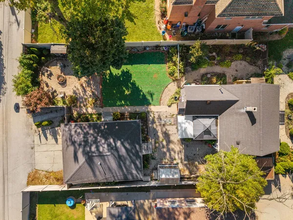 an aerial view of a house with swimming pool and outdoor space
