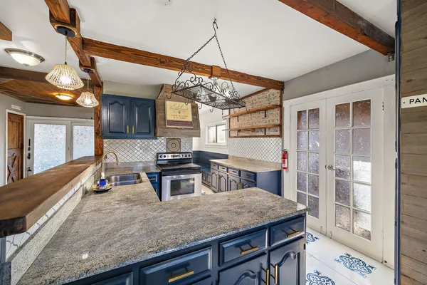 a kitchen with a sink stove and cabinets