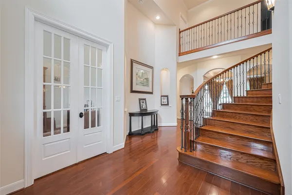 a view of entryway and hall with wooden floor