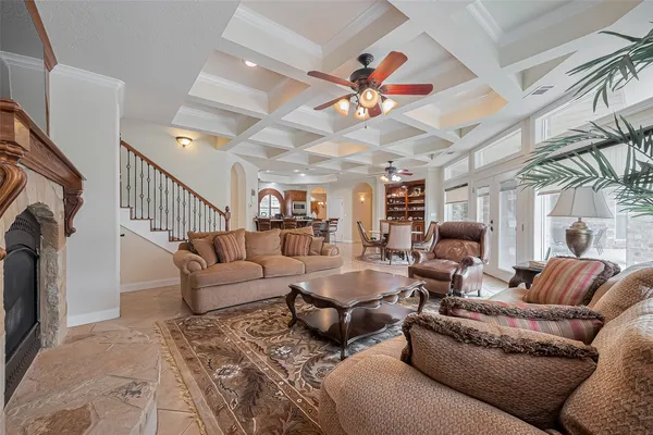 a living room with furniture ceiling fan and a rug