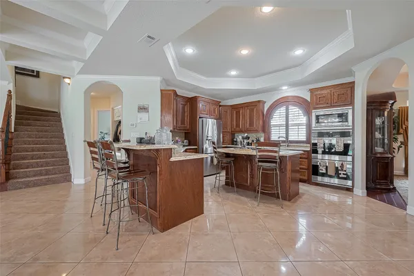 a kitchen with a sink and chairs
