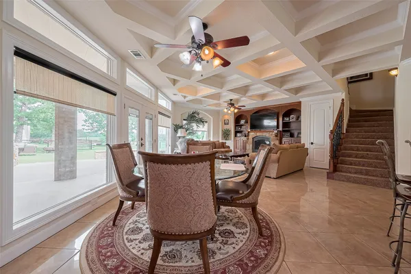 a dining room with furniture potted plants and wooden floor