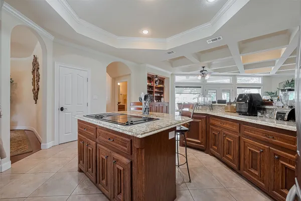a kitchen with stainless steel appliances granite countertop a sink and a refrigerator