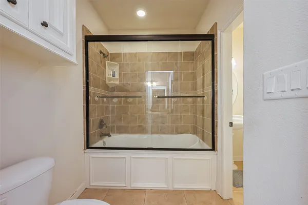 a bathroom with a glass shower door