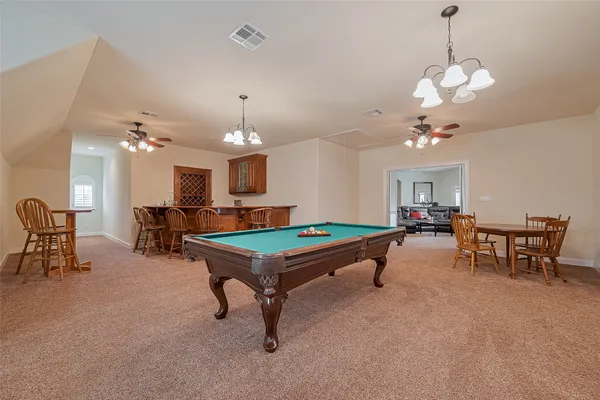 a room with furniture and pool table