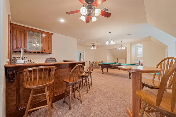 a dining room with furniture and a chandelier