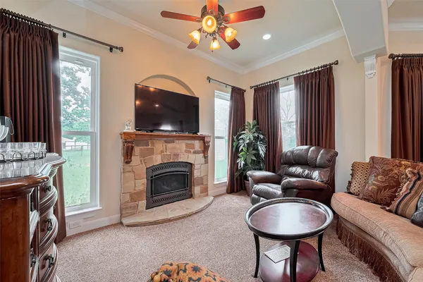 a living room with furniture a flat screen tv and a fireplace