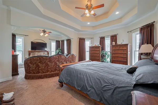 a bedroom with a large bed and flat screen tv