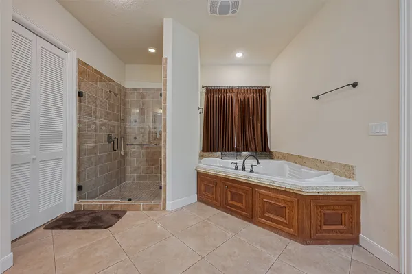 a bathroom with a granite countertop sink a toilet and shower