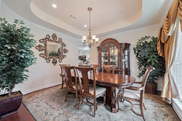 a view of a dining room with furniture and chandelier