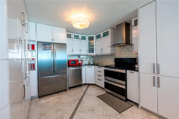 a kitchen with stainless steel appliances and white cabinets