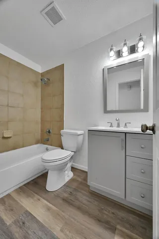 a bathroom with a bathtub sink mirror and toilet