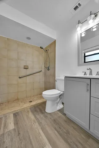 a bathroom with a toilet a sink and shower