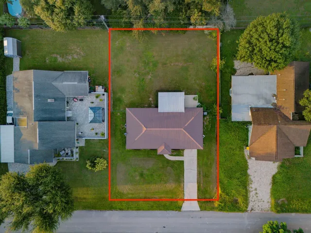 an aerial view of a house with a yard