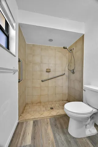 a bathroom with a toilet and shower