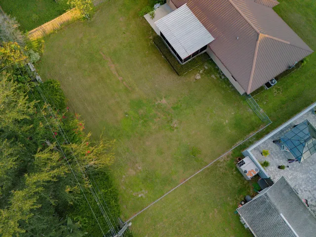 an aerial view of a house with a yard