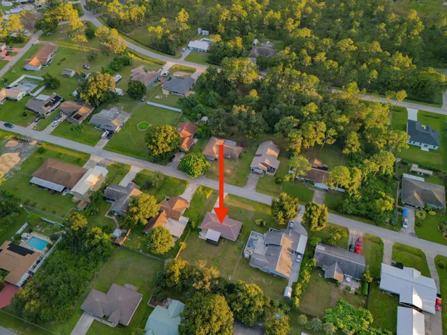 an aerial view of residential houses with outdoor space and street view