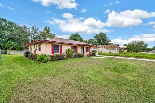 a view of house with backyard