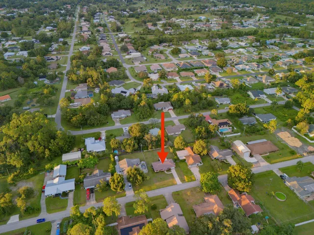 an aerial view of residential houses with outdoor space and street view