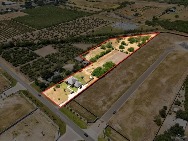 an aerial view of house with yard