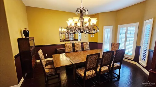 a view of a dining room with furniture and a chandelier