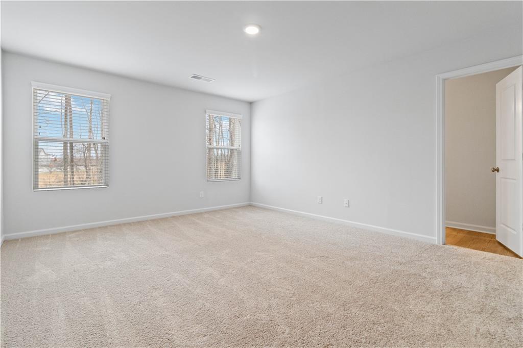 5113 Sidney Sq Drive Flowery Branch, GA 30542 - Photo 21 of 35 a view of an empty room with a window