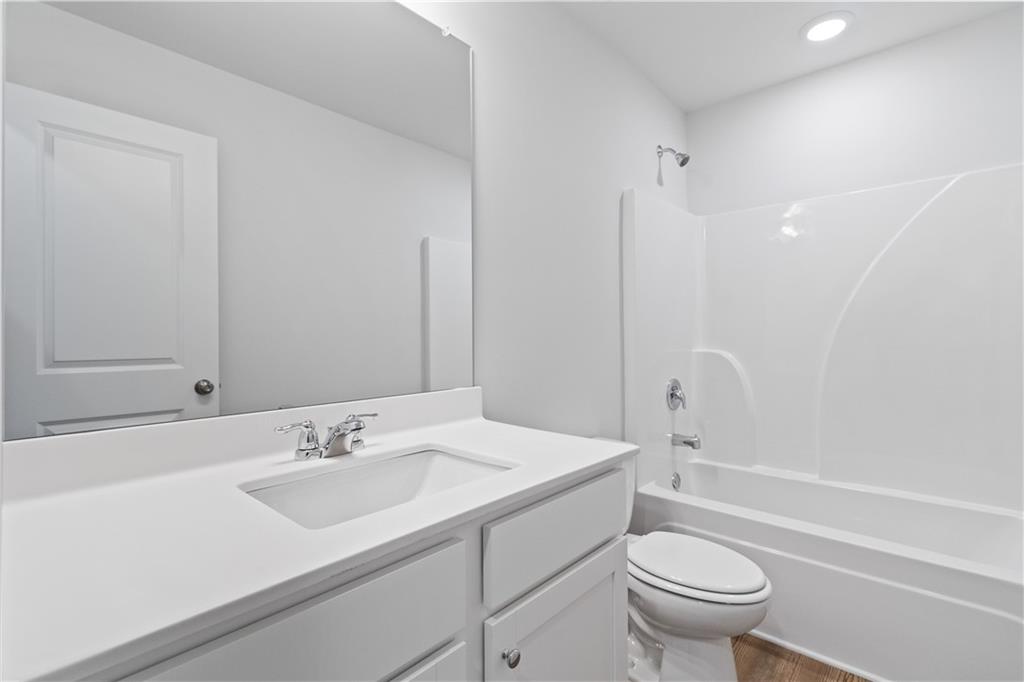 5113 Sidney Sq Drive Flowery Branch, GA 30542 - Photo 26 of 35 a bathroom with a sink toilet vanity and shower