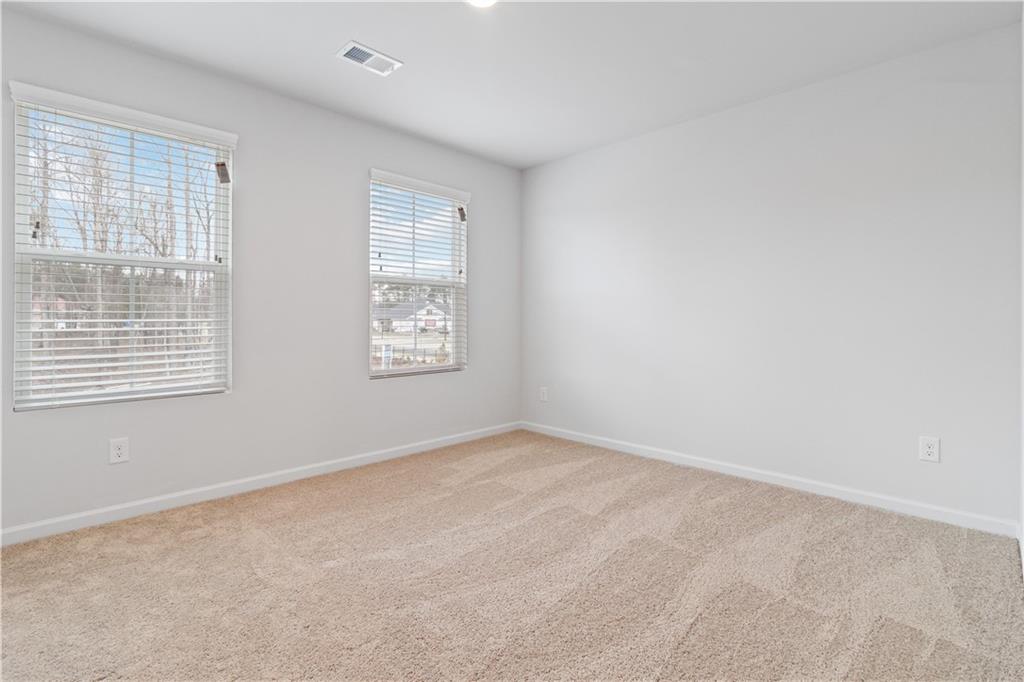 5113 Sidney Sq Drive Flowery Branch, GA 30542 - Photo 27 of 35 an empty room with windows