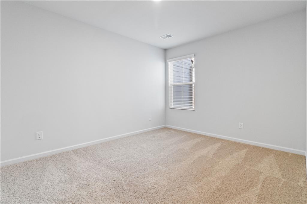 5113 Sidney Sq Drive Flowery Branch, GA 30542 - Photo 29 of 35 a view of an empty room with a window