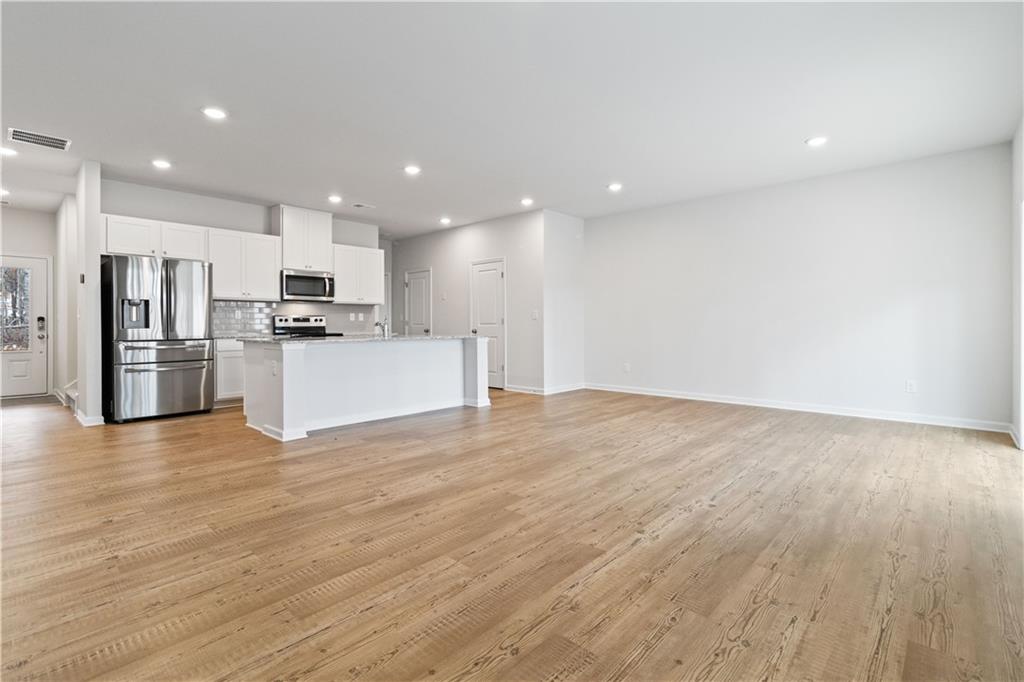 5113 Sidney Sq Drive Flowery Branch, GA 30542 - Photo 8 of 35 a view of a kitchen with a sink and a refrigerator