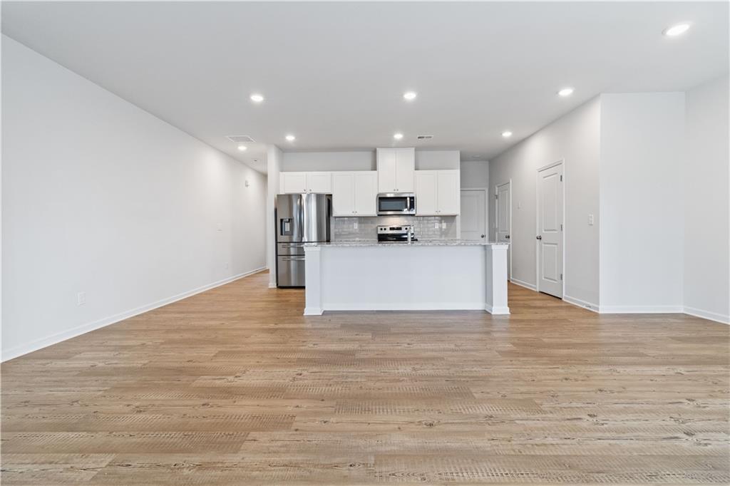 5113 Sidney Sq Drive Flowery Branch, GA 30542 - Photo 9 of 35 a view of large kitchen with wooden floor