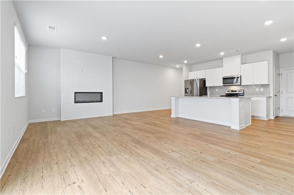 5113 Sidney Sq Drive Flowery Branch, GA 30542 - Photo 10 of 35 a view of kitchen with kitchen island microwave and stove