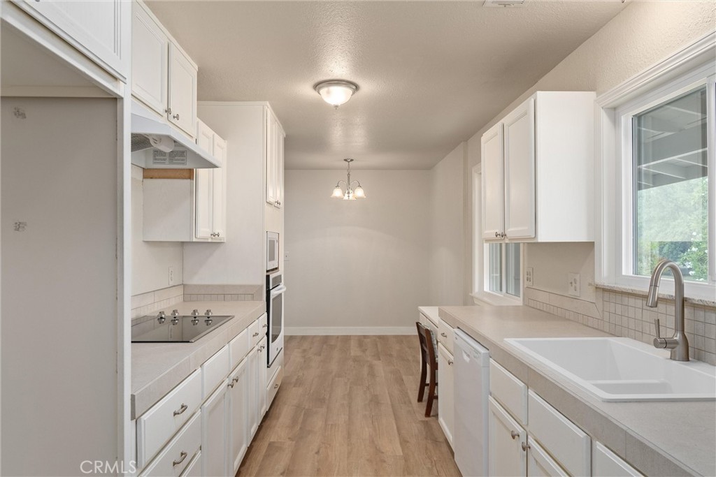 2737 House Avenue Durham, CA 95938 - Photo 16 of 49 a bathroom with a granite countertop sink a mirror and a shower