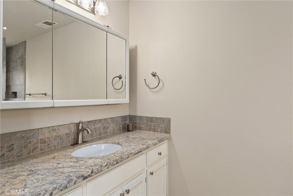 2737 House Avenue Durham, CA 95938 - Photo 24 of 49 a bathroom with a granite countertop sink and a mirror