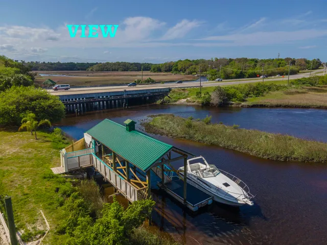 an aerial view of a house with a lake view