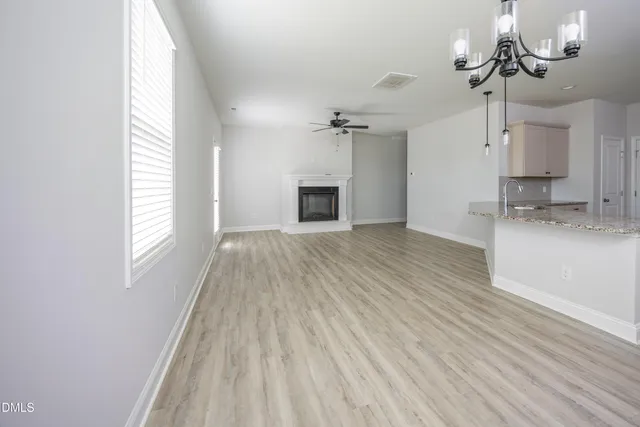 a view of a kitchen with a sink and dishwasher wooden floor