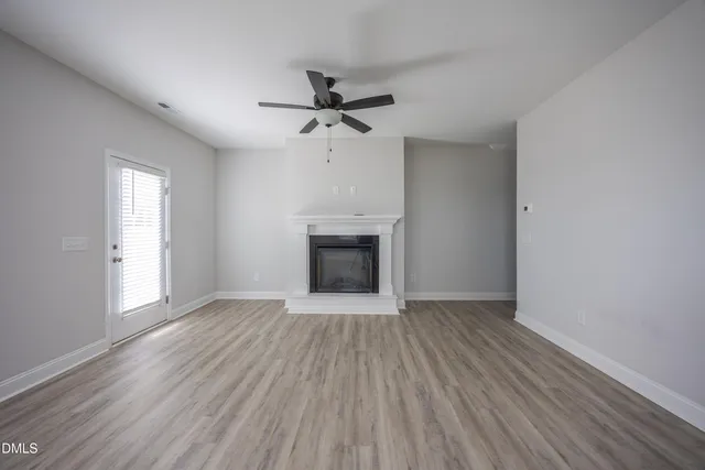 wooden floor in an empty room with a window