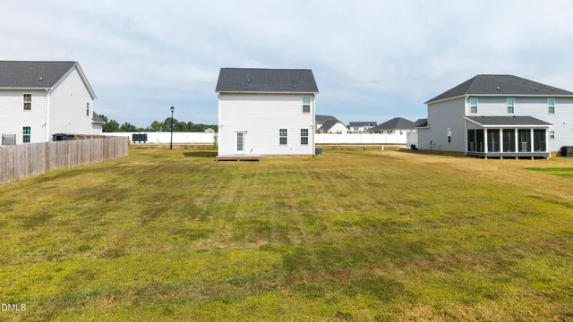 a view of residential houses with yard and swimming pool