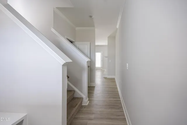 a view of hallway with wooden floor