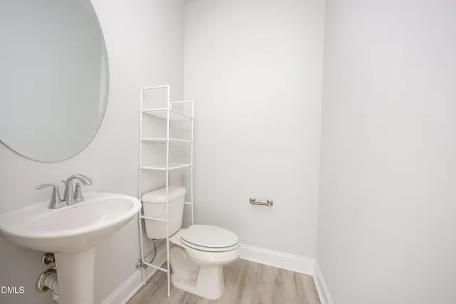 a view of a hallway with wooden floor and entryway