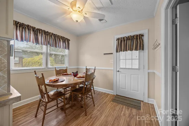 a view of a dining room with furniture window and wooden floor