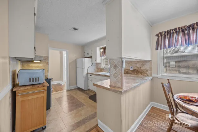 a view of kitchen with furniture and wooden floor