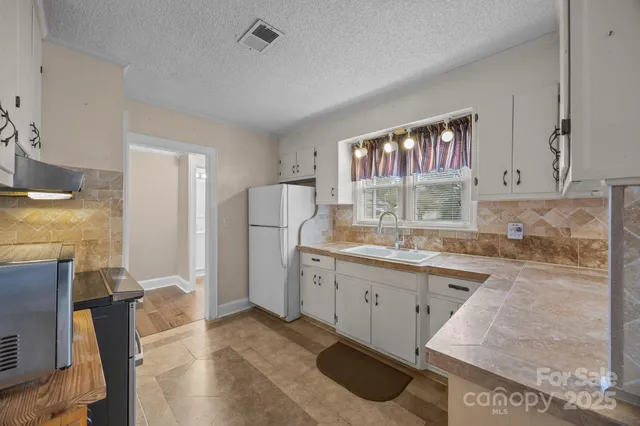 a kitchen with a sink stove and refrigerator