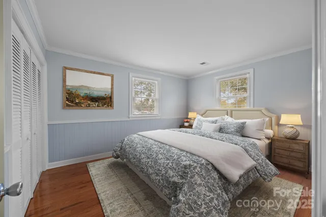 a bedroom with a large bed and a window