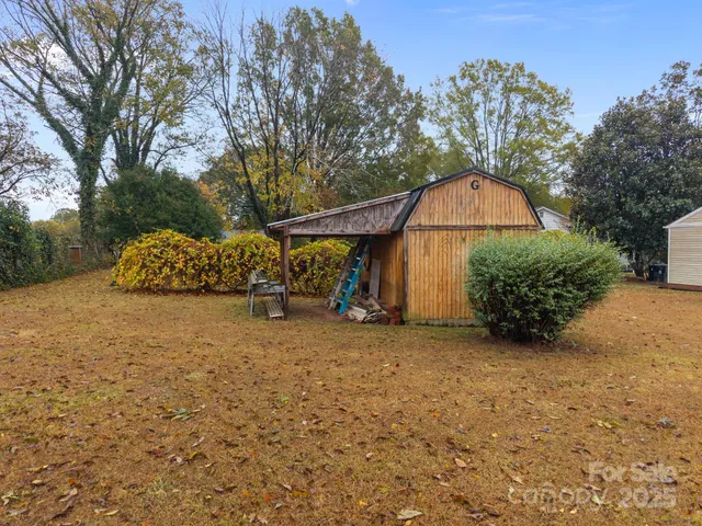 a view of a house with a yard and pathway