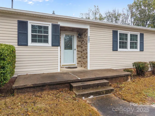 a view of a house with a yard and sitting area