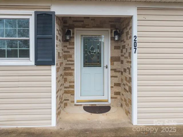 a view of a door of the house and a window