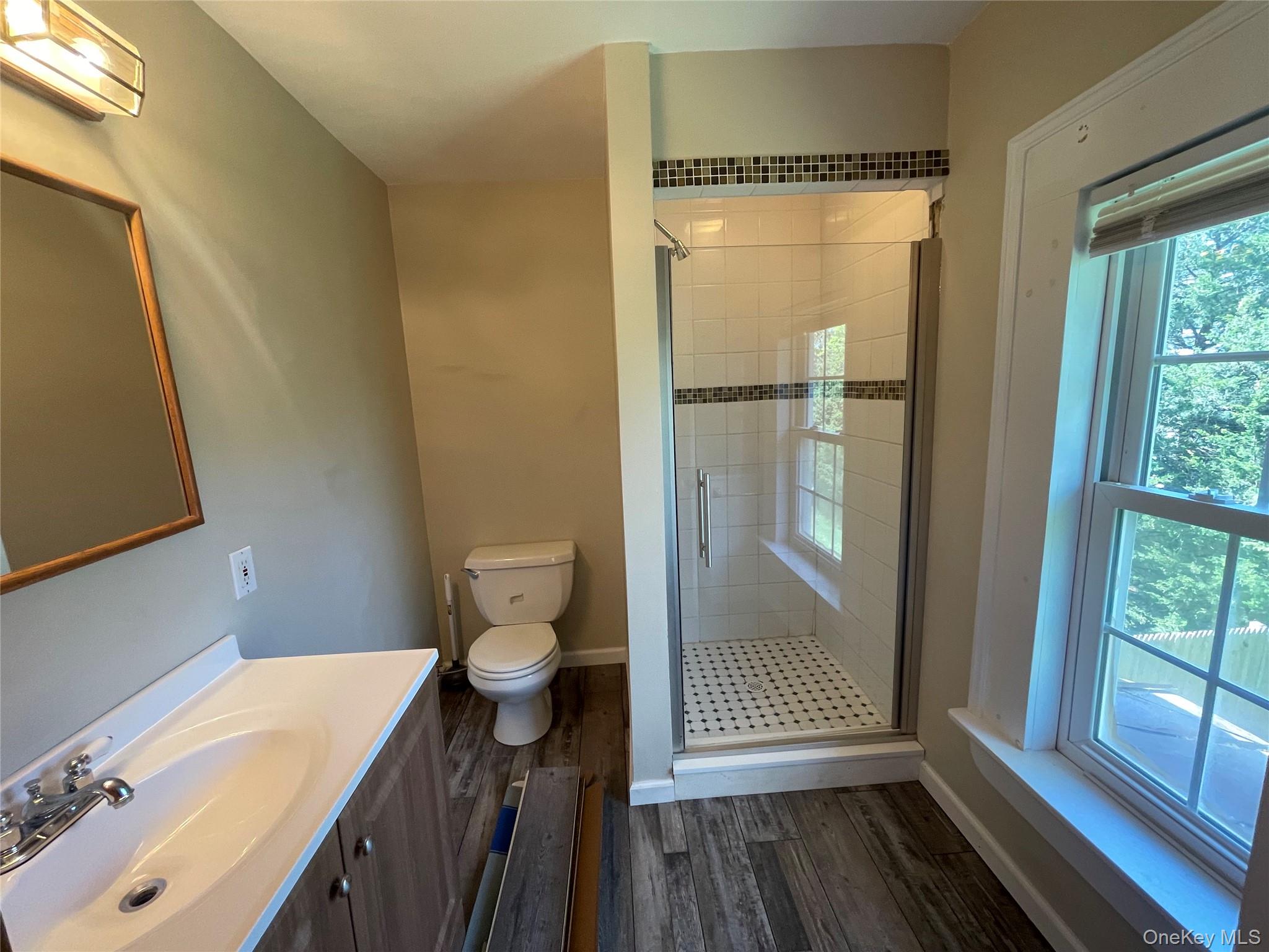 496 North Country Road St. James, NY 11780 - Photo 14 of 18 a bathroom with a sink a toilet and shower
